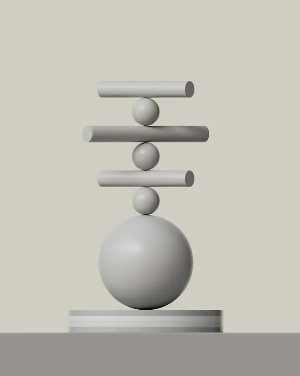 Smooth grey shapes stacked in careful balance