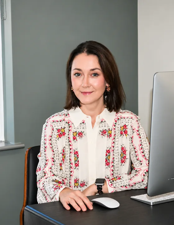 Dr. Yana Bekker, DO, seated at her desk