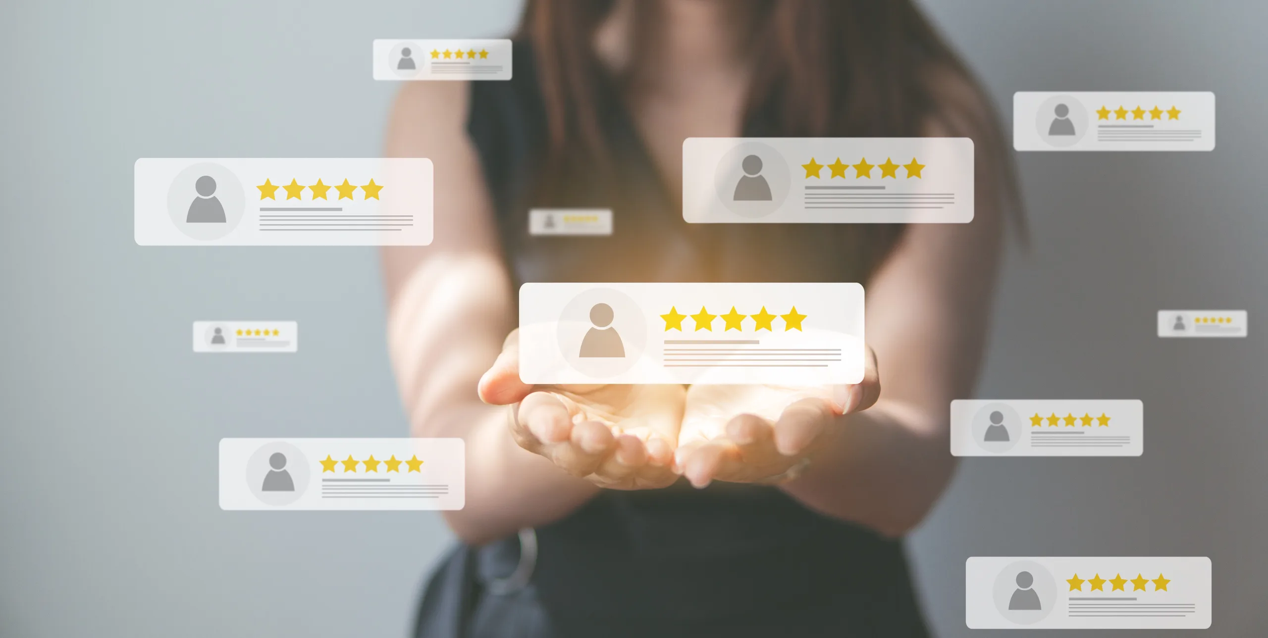 Cupped hands with a glowing five-star review card floating above them